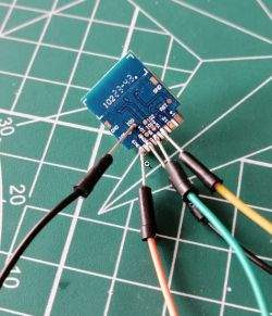 Close-up of an ESP-02s module with soldered wires.
