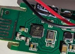 Close-up of an electronic board with LF686C20 chip and connected wires.