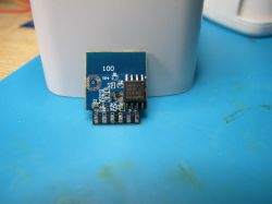 BL0937 Electronic Module on Blue Background Close-up of an electronic module on a blue background.