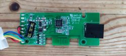 Circuit Board with Electronic Components Close-up of a circuit board with multicolored wires connected on the left side.