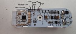 Close-up of a circuit board with markings for TX1, RX1, GND, 3.3V, and RST connections.