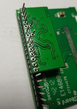 Circuit board with soldered pins and visible traces.