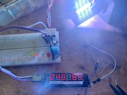Electronic Prototype Circuit with Display and LEDs Prototype electronic circuit on a breadboard with LEDs and a display.