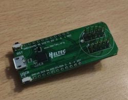 Heltec development board with micro USB port and pin headers on wooden desk