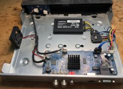 Samsung EVO 4TB SSD and circuit board with cables inside a metal device enclosure
