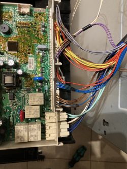 Dishwasher control board with wires and electronic components.
