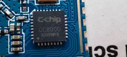 Close-up of C-chip CC8000 integrated circuit on a blue electronic board.