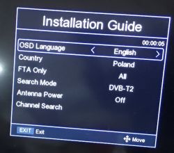 TV screen showing “Installation Guide” menu with DVB‑T2 settings for Poland