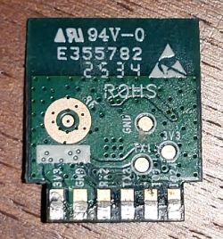Small green PCB with pin labels, ROHS marking, and code E355782