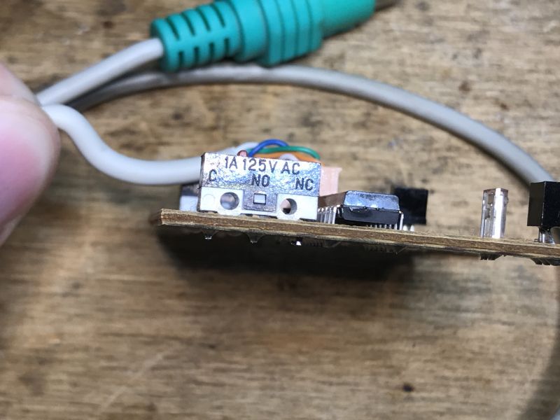 Inside Circuit Board of a Computer Mouse Inside view of a circuit board from an old computer mouse with visible wires and a PS/2 connector.
