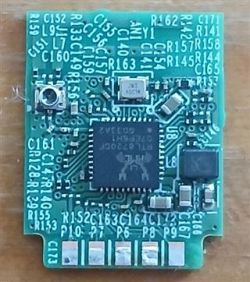 Close-up of a small PCB with an integrated circuit and surface-mount components