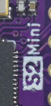 Fragment of a purple circuit board with the label S2 Mini.