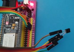 ESP32 board with jumper wires on a pin-labeled carrier, plus a TO-92 sensor on three leads