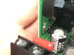 Zbliżenie na elementy elektroniczne na płytce drukowanej, widoczny kondensator 400V.