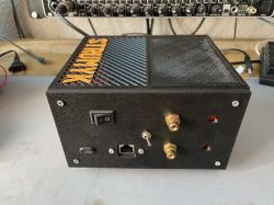 Black plastic device case with switches, ports, and SYRNYX label on top