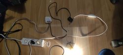 Electrical circuit with an energy monitoring module connected to a power strip on the floor.