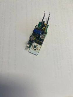 Small printed circuit board with various electronic components on a white background.