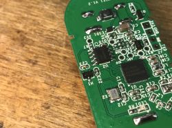 Disassembled PCB of Sonoff DW2-Wi-Fi Sensor Close-up of the PCB of a Sonoff door sensor with visible electronic components.