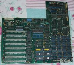Two green PCBs with DIP chips and many edge expansion connectors on patterned fabric