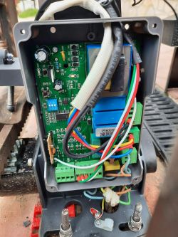 Electronic Controller for Automatic Gate The inside of a casing with a visible circuit board and electrical wires.