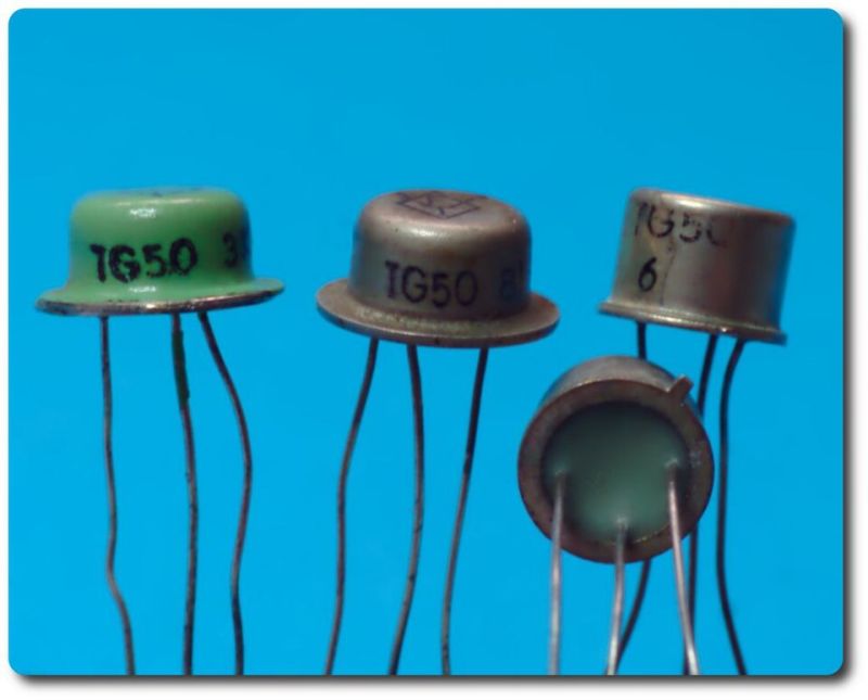 Four TG50 germanium transistors in metal can packages on a blue background