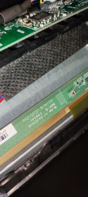 Close-up of a T-CON board inside a television.