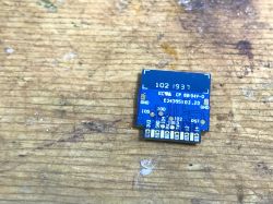 TYWE2S Module on a Workbench Electronic module TYWE2S on a wooden background