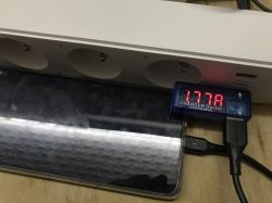 Power strip with a “CHARGER Doctor” USB meter plugged in, showing 1.77 A