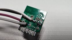 Photo of the back of a printed circuit board with soldered wires.