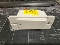 Three-Way Electric Switch from AliExpress Three-way electric switch from AliExpress lying on a black mat with a world map.
