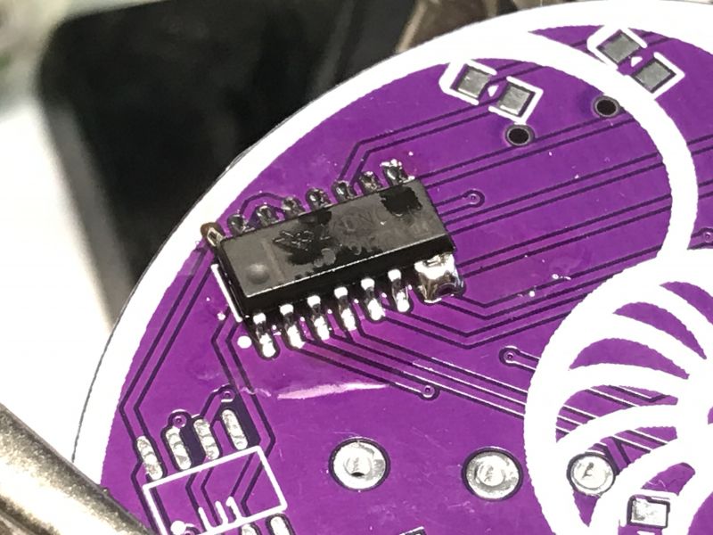 Integrated Circuit on PCB Close-up of a surface-mounted (SMD) integrated circuit soldered to a purple PCB.