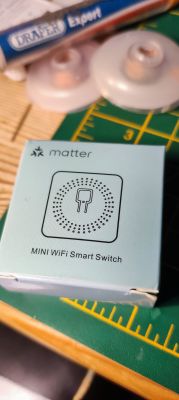 Box labeled Matter MINI WiFi Smart Switch on a green mat background.