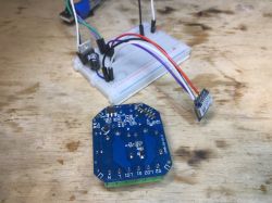 Woox R7279 Relay Module with Built-in Buzzer PCB of the Woox R7279 relay module with a buzzer on a wooden table.
