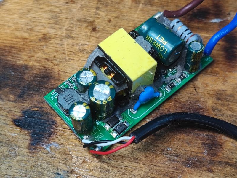 LED Power Supply Module with Capacitors on PCB Close-up of a power supply module with visible capacitors on a circuit board.