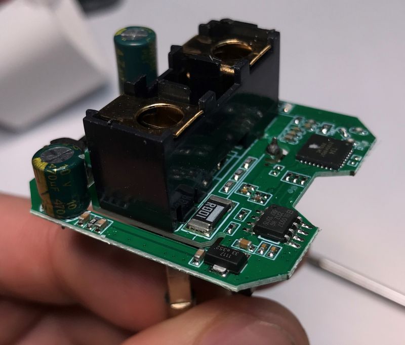 Close-up of a Printed Circuit Board with Electronic Components Close-up of a green printed circuit board held in hand with electronic components such as capacitors and microchips.