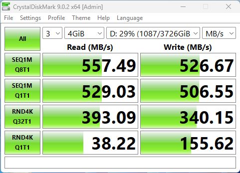 Okno CrystalDiskMark z wynikami testu dysku: odczyt 557,49 MB/s i zapis 526,67 MB/s.