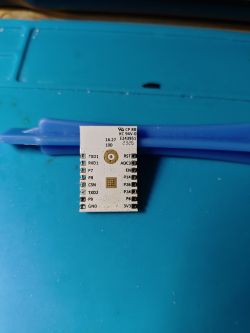 Electronic module with pin labels on a blue background.