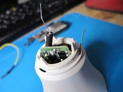 Open plastic casing with a visible circuit board and protruding wires.