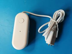 White leak sensor with a button and cable on a blue background.