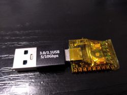 USB adapter connected to a RP2040 board wrapped in yellow insulation tape