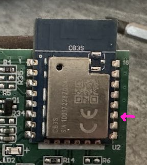 Close-up of the CB3S module on a circuit board with one pin marked by a pink arrow.