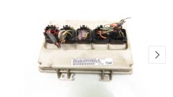 Moduł samochodowy z kilkoma podłączonymi wtyczkami i kolorowymi przewodami.