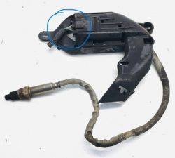Damaged NOX sensor with casing and wire.