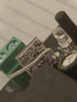 TYLC5 Component on Circuit Board Close-up of electronic component TYLC5 on a circuit board with a relay and LED.