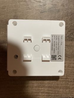 Back of a 3-phase energy meter with manufacturer label.