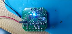 SW02-02 Switch Printed Circuit Board Printed circuit board with electronic components and a blue LED on a blue background.