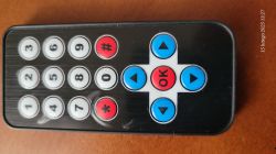 Remote control with numeric and navigation buttons.
