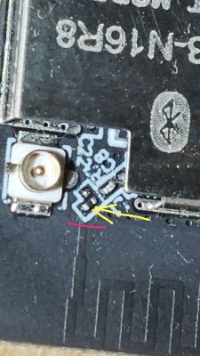 Close-up of a PCB showing a jumper and a trace marked for cutting.