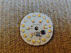 Round circuit board with arranged LEDs and electronic components.