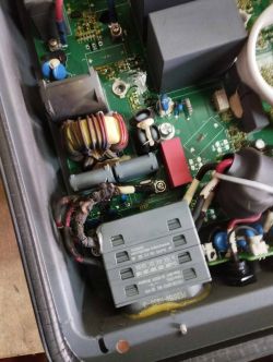 Burnt photovoltaic inverter with visible circuit board damage.